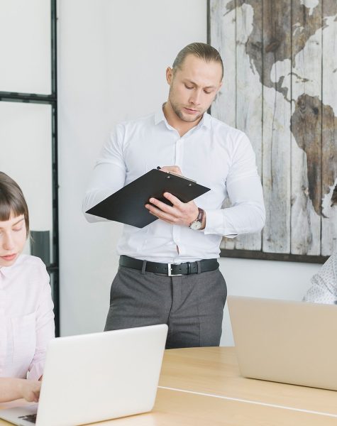 Consultant reviewing documents for mainland company formation in Dubai, UAE with business team
